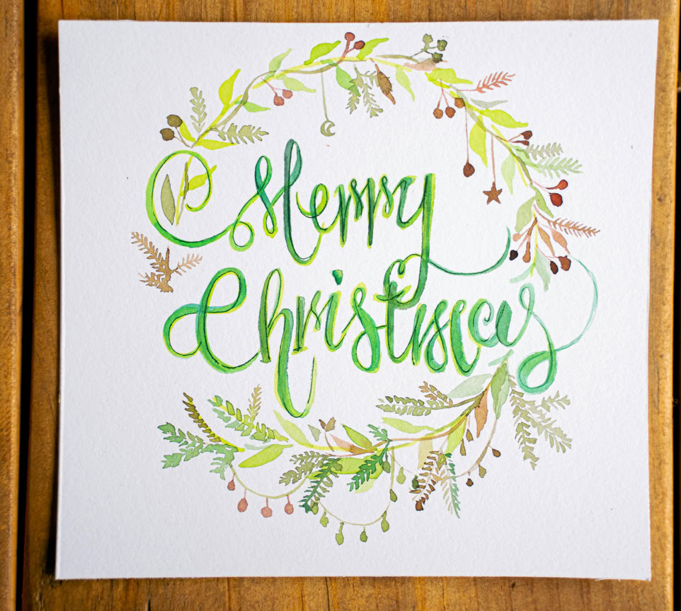 Beautiful handmade Merry Christmas card with artistic calligraphy and festive design.