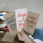 Close-up of handcrafted greeting cards for Father's Day, Mother's Day, and Lunar New Year.