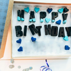 Top view of a birthday gift box with 'Happy Birthday' letters and blue heart decorations.